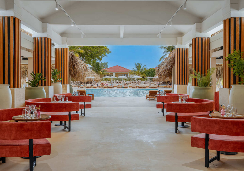 Mondi restaurant with red booths overlooking the pool