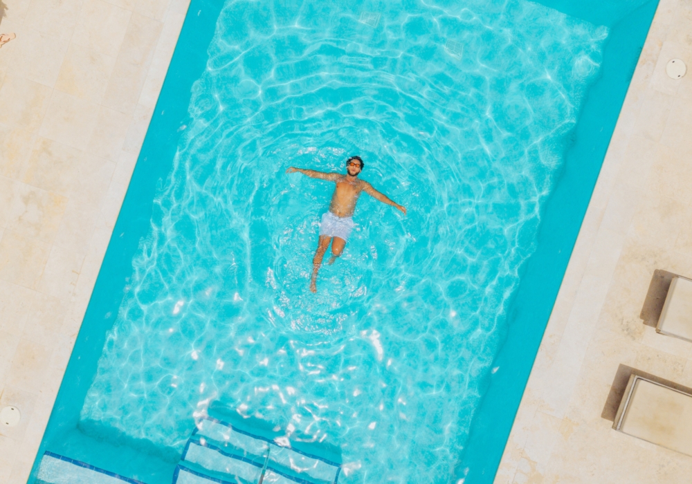 a swimmer in the resort pool, seen from above